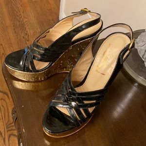 Black patent with gold platform sandals. In good condition-no box